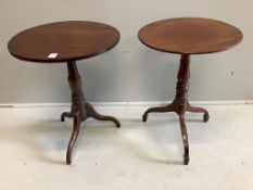 A near pair of Victorian circular mahogany tripod wine tables, larger diameter 57cm, height 71cm.