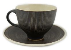 Dame Lucie Rie D.B.E. (1902-1995), a manganese glazed coffee cup and saucer, the cup with incised