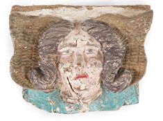 A 16th century French carved and painted wooden angel mask corbel, thought to have originated from