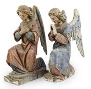 A pair of late 19th century polychrome carved painted pine praying archangels, each kneeling upon
