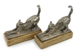 Louis Riché (French, 1877-1949), a pair of silvered bronze bookends modelled as stretching cats,