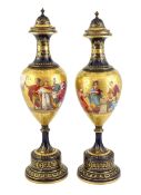 A pair of tall Vienna style porcelain vases and covers, early 20th century, each painted by B.