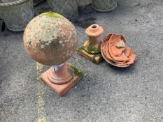 A large pair of weathered terracotta sphere garden ornaments, one in need of restoration, height