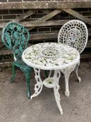 A Victorian style painted aluminium circular garden table, diameter 56cm, height 65cm, and two