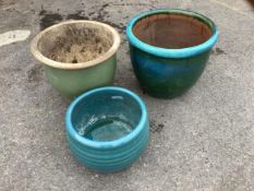 Three circular turquoise glazed earthenware garden planters, largest diameter 50cm, height 42cm.