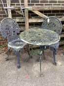 A Victorian style circular painted aluminium garden table, diameter 64cm, height 66cm, and two