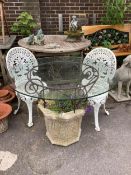 A reconstituted stone and wrought iron glass top garden planter/table, diameter 100cm, height