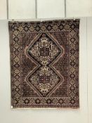 A Persian mauve ground rug, 139 x 174cm. Condition - poor