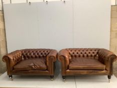 A pair of modern Victorian style buttoned tan leather small Chesterfield settees, width 154cm, depth
