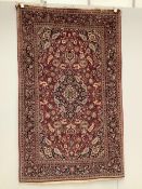 An Isphahan blue medallion rug, with a pink field, 210 x 128cm. Condition - fair