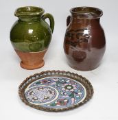 From the Studio of Fred Cuming. Two studio green and brown glazed jugs together with an enamelled