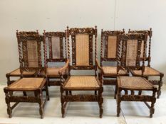 A set of seven Jacobean Revival caned oak dining chairs, one with arms. Condition - fair