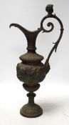 A Cellini style bronze ewer, possibly converted to a lamp later, decorated with putti panel and head