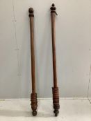 Two Victorian mahogany and pine curtain poles with rings, larger width 161cm. Condition - fair