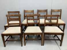 A harlequin set of seven early 19th century provincial elm and fruitwood dining chairs.