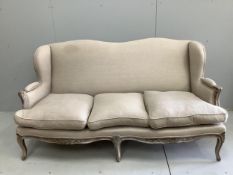 A Louis XVI style painted upholstered settee, width 180cm, depth 70cm, height 93cm. Condition -