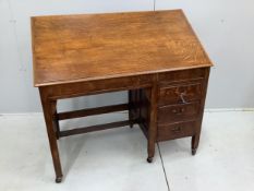 An Arts & Crafts metamorphic oak patent kneehole architect's desk, fitted three small side