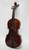 A late 19th century three quarter length violin with label; 'Medio-Fino', back measures 33cm.