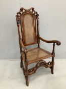 A William and Mary walnut and beech armchair, with a patera carved crest rail, and square and scroll