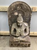 A South East Asian carved stone Buddha, width 39cm, height 79cm. Condition - good