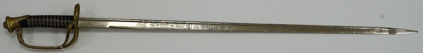 A Belgian WWI infantry officer’s pipeback sword, blade etched with crowned A ‘Albert I’ and ‘Pour le