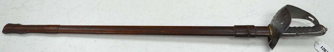 An 1898 pattern British NCO’s sword with leather scabbard, Edward VII cipher to guard, the blade