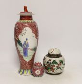 An early 20th century Chinese famille rose vase and cover, a similar small jar and cover and a