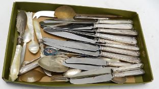 A small group of assorted silver and white metal cutlery including teaspoons, mother of pearl