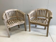 A pair of weathered teak garden 'banana' chairs, width 78cm, depth 52cm, height 82cm. Condition -