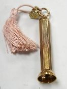 A modern engine turned 9ct gold cigar piercer, overall 67mm, gross weight 15.8 grams. Condition -