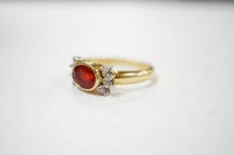 A modern 18ct gold, single stone fire opal? and eight stone diamond chip set dress ring, size L/M,