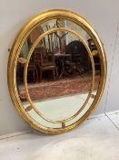 A George III style oval giltwood marginal plate wall mirror, width 98cm, height 125cm. Condition -