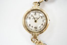A lady's gilt metal manual wind wrist watch, the dial inscribed 'Rolex Standard', movement
