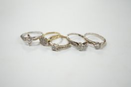 Four assorted 18ct, plat and diamond rings, including two solitaires and a flower head cluster,