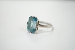 A mid 20th century white metal (stamped platinum) and single stone emerald cut blue zircon set ring,