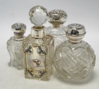 Four assorted early 20th century silver mounted glass scent bottles, tallest 16.1cm. Condition -