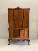 A Queen Anne Revival walnut cocktail cabinet, width 94cm, depth 48cm, height 160cm. Condition -