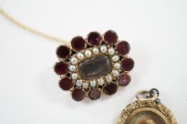 An early Victorian yellow metal, garnet and split pearl set mourning brooch, with engraved monogram,