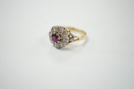 A yellow metal ruby and diamond cluster set flower head ring, size I/J, gross weight 3.6 grams.