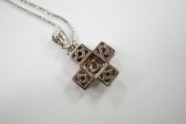 A modern 18ct white gold and diamond cluster set cross pendant, overall 25mm, on an 18ct white