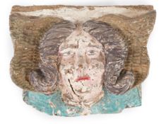 A 16th century French carved and painted wooden angelic corbel mask, thought to have originated from