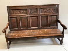 A mid 18th century carved oak settle, width 171cm, depth 58cm, height 122cm. Condition - poor to