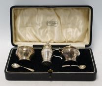 A cased George V silver three piece condiment set, Z. Barraclough & Sons, Chester, 1931, with two