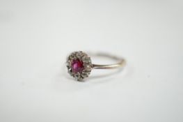A 1940's 18ct white metal, ruby and diamond set circular cluster ring, size N/O, gross weight 1.9