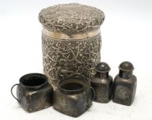 A Chinese embossed white metal cylindrical jar and cover, 11.2cm, and a similar white metal four