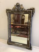 A French decorative wall mirror with cherub motifs, (later painted), width 81cm, height 127cm.