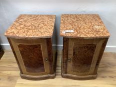 A pair of early 20th century French amboyna and mahogany marble top bedside cabinets, width 40cm,