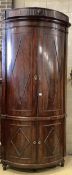 An unusually tall late 18th century Dutch mahogany bow fronted corner cabinet, in two sections,