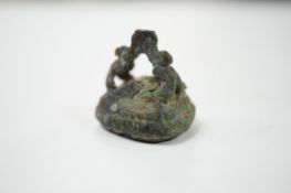 A Roman base metal intaglio seal, carved with a figure?, 20mm. Condition - poor