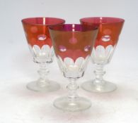 Twelve red lustre cut glass, stemmed wine glasses. 15cm high. Condition - fair to good